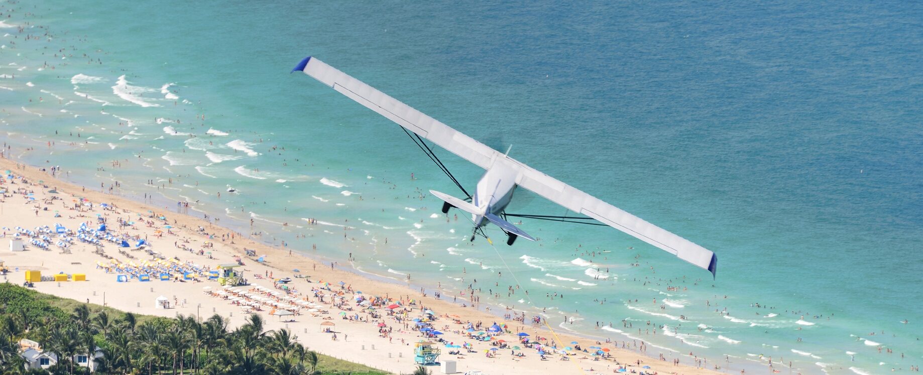 Banner Towing Piper Cub over beach