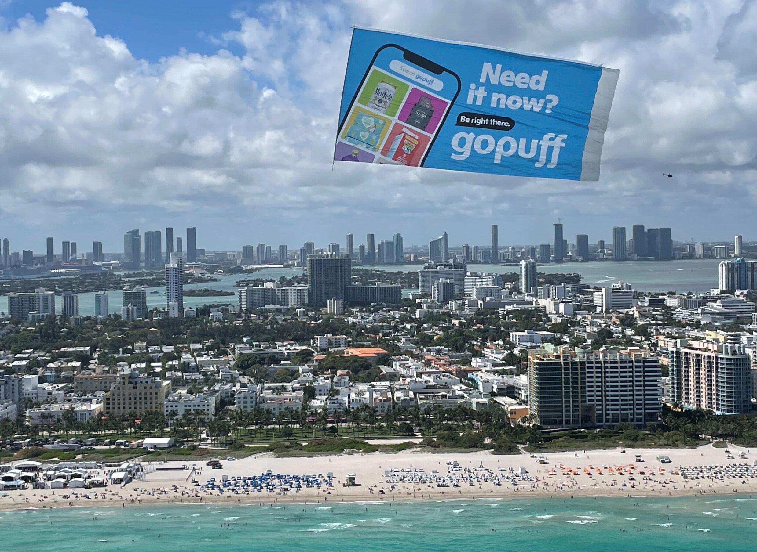 Delivery service sky banner, Aerial delivery advert beachside